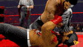 two wrestlers are wrestling in a ring with a referee and a tag that says raw