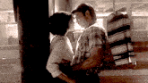 a man and a woman are standing next to each other and looking into each other 's eyes