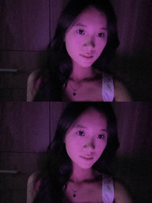 a woman 's face is shown in purple light and in a dark room