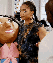 a woman is holding a large puppet of a woman in a room .