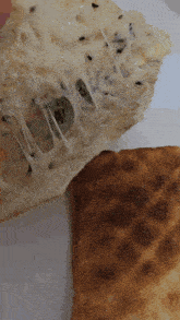 a close up of a piece of pizza with cheese pulling out of it