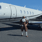 a man standing in front of a white airplane
