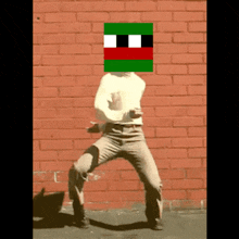 a person standing in front of a brick wall with a pixelated face