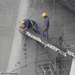 a gif of two construction workers being saved by the safety belt