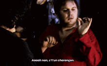 a man in a red shirt says aaah nan c't'un charangon