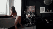 a woman in lingerie is dancing in front of a window with imgflip.com at the bottom of the screen