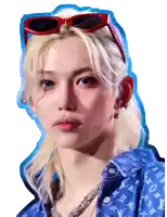 a man with blonde hair wearing sunglasses and a blue shirt with louis vuitton on it