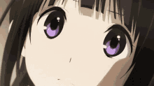 a close up of a girl 's face with purple eyes and black hair