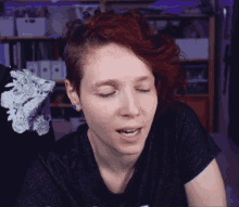 a woman with red hair is wearing a black shirt that says ' i love you ' on the front