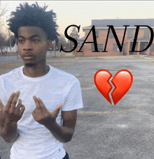 a man in a white shirt stands in front of a broken heart and the word sand on the bottom