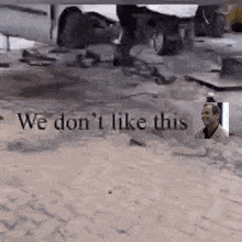a man is standing in front of a sign that says we don t like this
