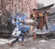 a man in a red cape is kicking a woman in the face