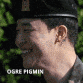 a close up of a man 's face with ogre pigmin written below him