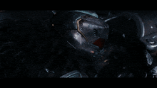 a close up of a futuristic helmet with a red light