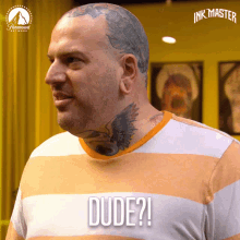 a man with a tattoo on his neck has the word dude on his shirt