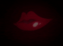 a close up of a woman 's mouth with a tongue sticking out