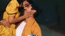 a man and a woman are hugging and kissing each other .
