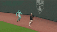 a man in a green costume is walking on a track