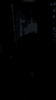 a black and white photo of a person in a room with a lot of boxes
