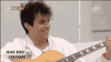 a young man is playing a guitar on a tv screen that says amici