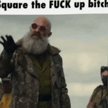 a man with a beard is wearing sunglasses and a camouflage jacket