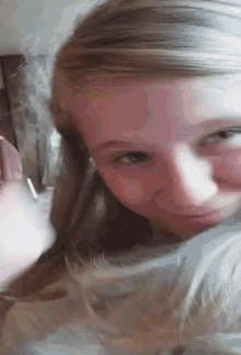 a close up of a girl 's face with her eyes closed