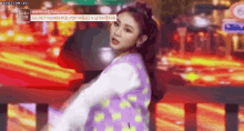 a girl with red hair is dancing on a stage with a sign that says secret number on it .