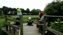 a group of people playing drums on a wooden deck