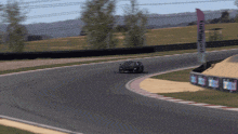 a race car is going around a curve on a track with a sign that says poder