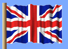 a red white and blue british flag is waving in the wind