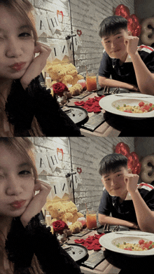a boy and a girl are sitting at a table with a plate of food and a banner that says " aww "