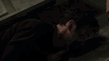 a man with blood on his face is laying on the floor with his eyes closed