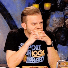 a man wearing a black shirt that says port or local library