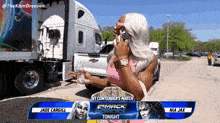 a woman is talking on a cell phone in front of a truck that says # 1 contender 's match