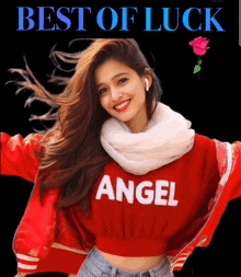 a woman wearing a red sweater that says angel is smiling
