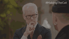 a man in a suit and tie says yes in front of another man