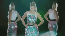 a woman in a crop top and sequined skirt dancing