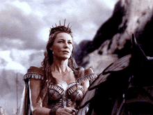 a woman wearing a crown is standing next to a horse