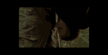 a man in a tank top is laying on the ground with his mouth open .