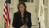 a woman stands at a podium with the word of the president on the front