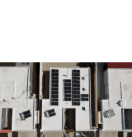 an aerial view of a row of houses with solar panels on the roof