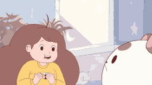 a girl in a yellow sweater holds a bee in her hands
