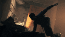a man is jumping in the air in front of a sign that says ' elevator '