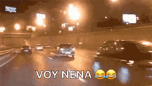 a picture of a highway at night with the words voy nena written on it