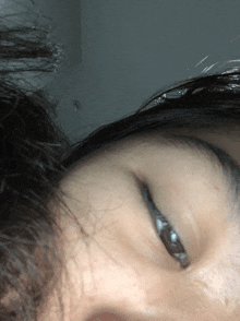 a close up of a person 's face with their eyes open