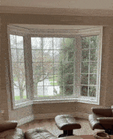 a living room with a bay window and a couch