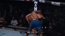 a fighter is being lifted in the air by another fighter during a ufc match