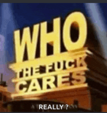 a sign that says who the fuck cares really ? on top of a building .