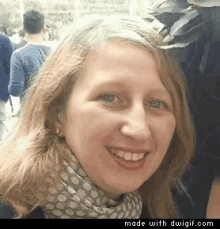 a woman wearing a scarf and earrings smiles for the camera with the words made with dwgif.com below her
