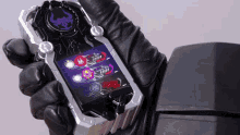 a person wearing black gloves is holding a device that says ' x-force ' on the front